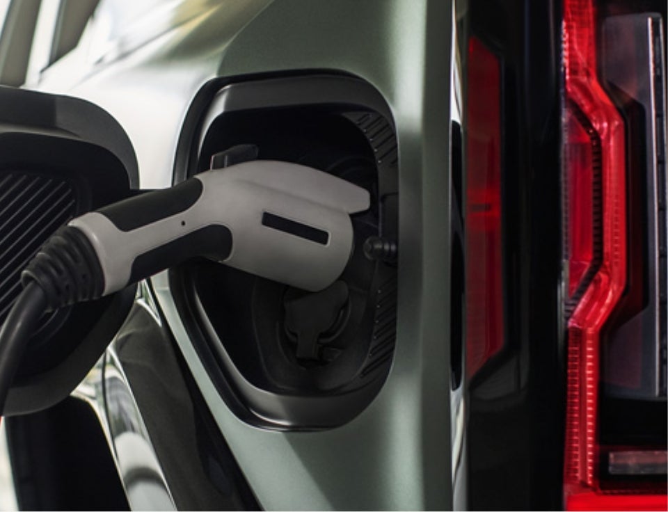 Close up of charging port with charger plugged in on a GMC Hummer EV SUV - Guys GMC Truck in RANSON WV